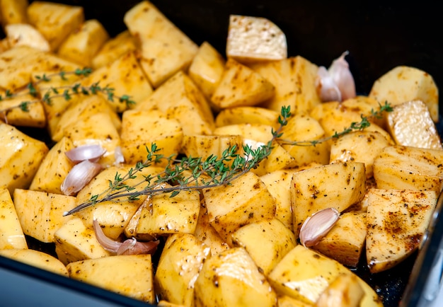 Potatoes prepared for baking with herbs.