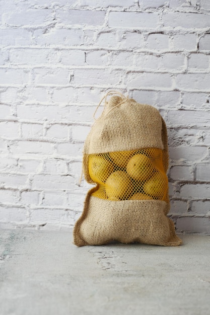 Potatoes in a sack bag on table