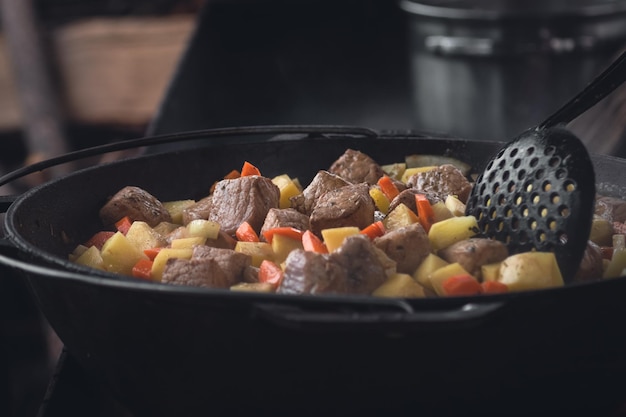 Potatoes with meat stewed in a cauldron over an open fire Ukrainian cuisine