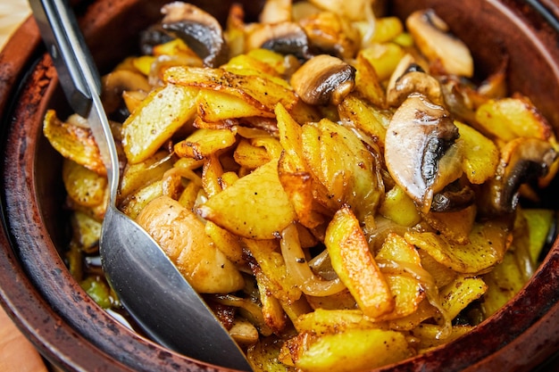 Potatoes with mushrooms baked in a pot