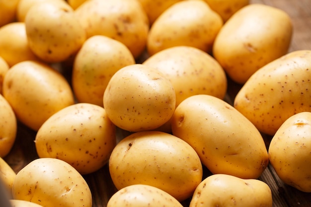 Potatoes on wooden background