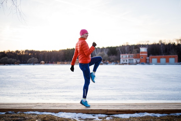 Potrtait of young athlete blonde at morning exercises in winter