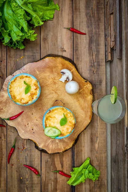 Pots with mushroom julienne on a wooden board View from above