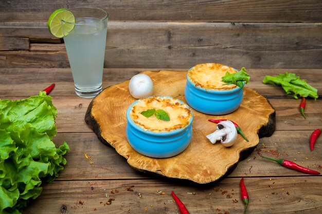 Photo pots with mushroom julienne on a wooden board