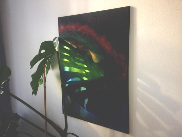 potted plant by painting on wall