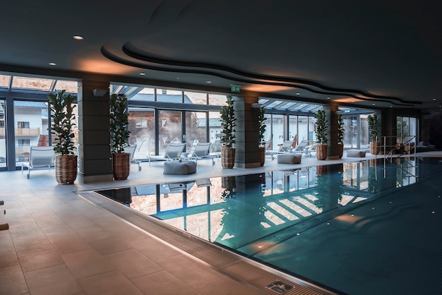 Potted plants by columns in front of swimming pool at luxury hotel