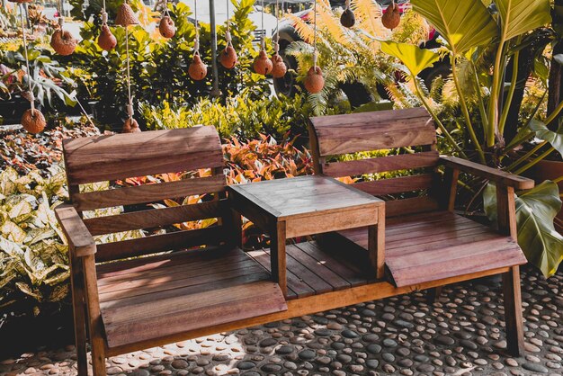 Potted plants on table by bench