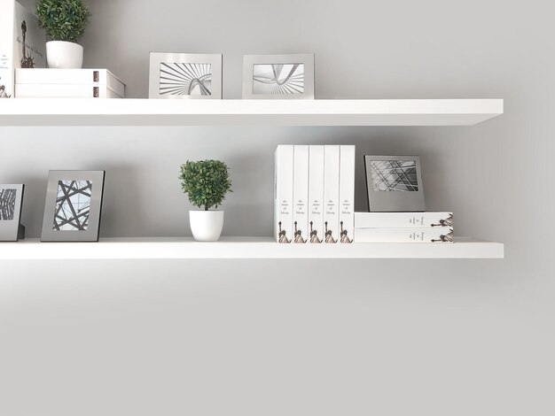 Photo potted plants with decor on shelf against white wall at home