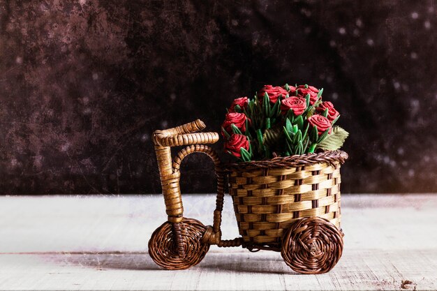 Potted roses on bike.