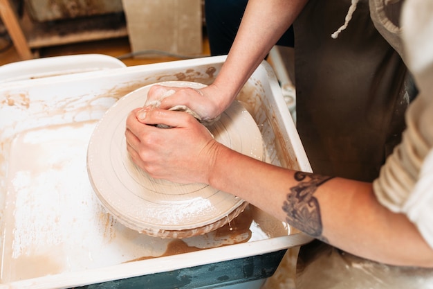 Potter hands in process of work