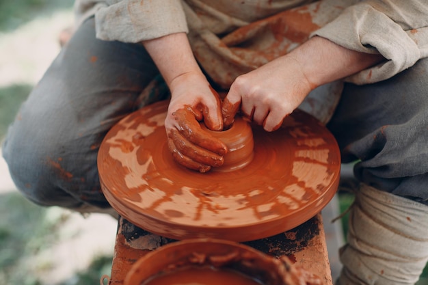 Potter makes a pot of clay