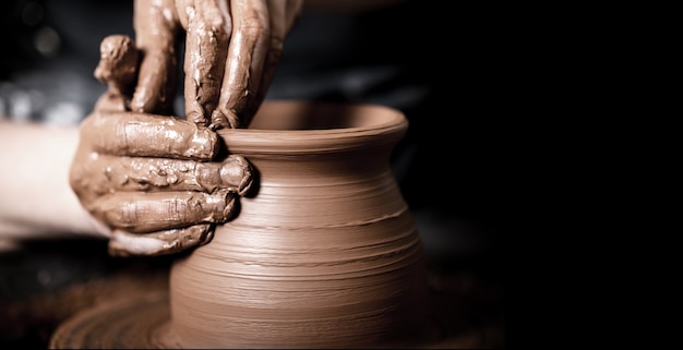 Potter making clay pot, close-up view