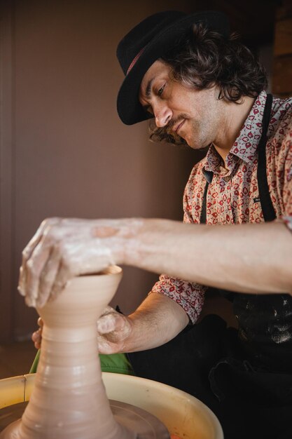 Potter master creating new ceramic jug