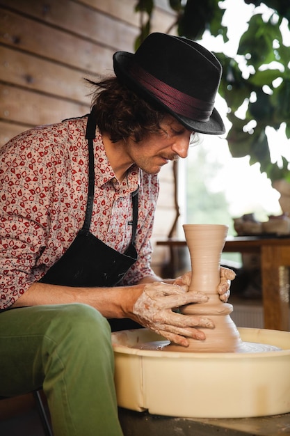 Potter master creating new ceramic jug