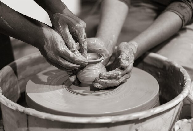 Potter shaping clay on the pottery wheel