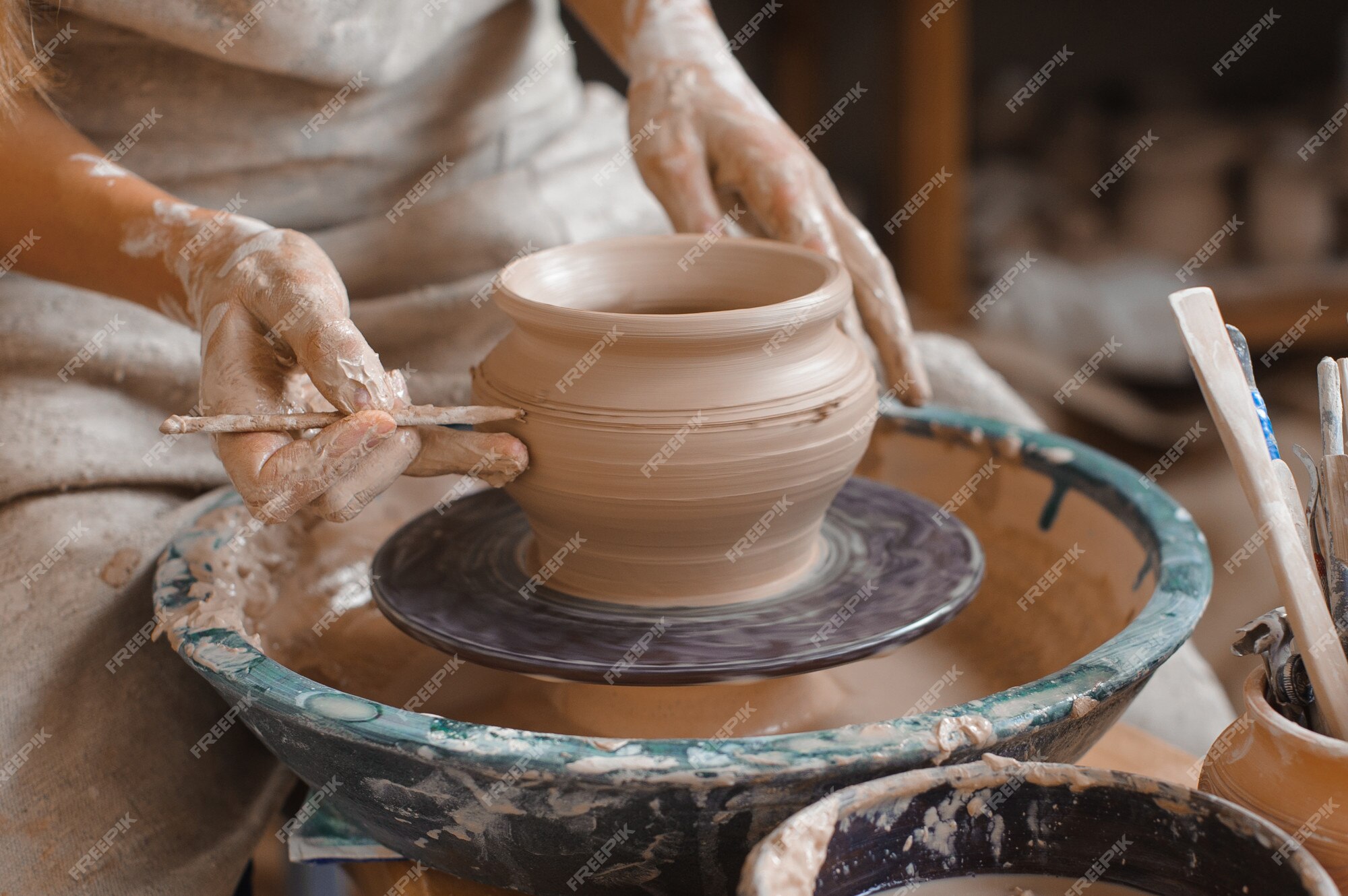 Premium Photo  Freshly made clay pot on a potters wheel