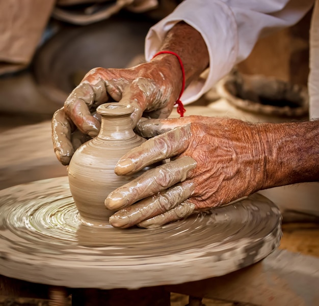 Potter at work makes ceramic dishes India Rajasthan