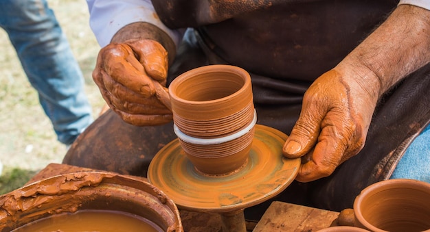 Potters hands shaping up the clay