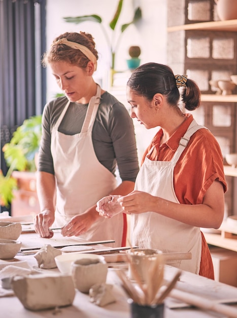 Pottery ceramic and teacher with student in workshop training learning and sculpture class production Clay design mentor and creative women or artist working together on mold for industry process