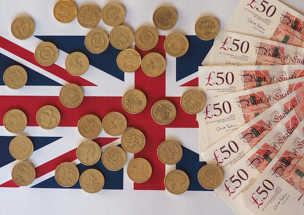 Pound coins and notes, United Kingdom over flag