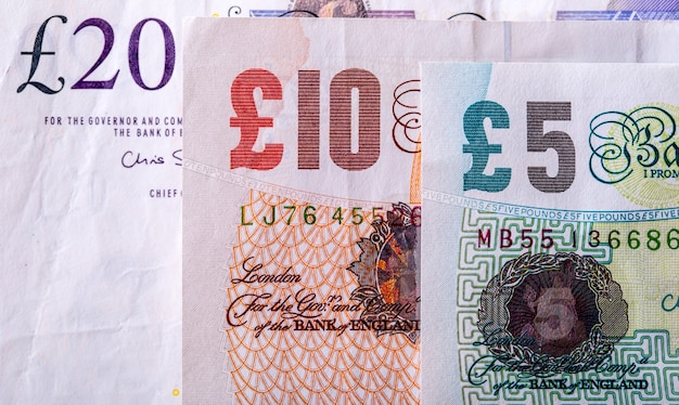 Pound currency, money, banknote.  English currency. UK banknotes of different values stacked on each other.