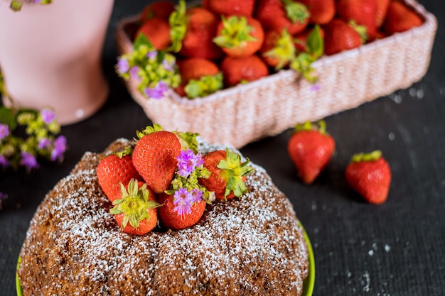 Pound vanilla cake and basket with fresh strawberries.