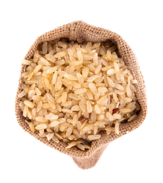 Pounded unripe rice in jute sack isolated on white surface