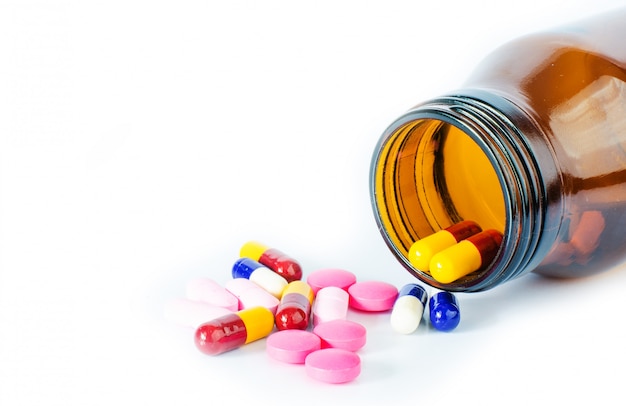 pour a bottle of pills on a white background.