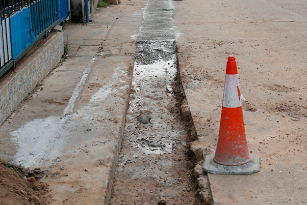 写真 田舎の村の道路のパイプラインにコンクリートを注ぎます。