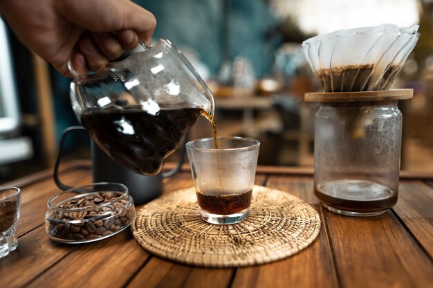 Pour hot water into coffee.,drip coffee on a wooden table at home