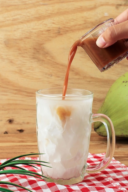 Es Kelapa Muda Young Coconut Ice에 액상 야자 설탕을 붓습니다.