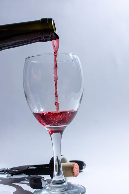 Pour red wine from the bottle into a glass