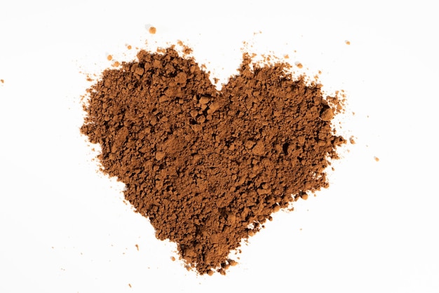 Poured heartshaped cocoa powder solated on white background