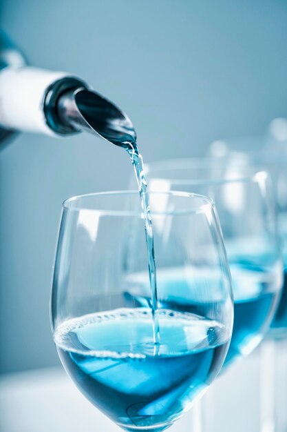 Pouring blue wine close up