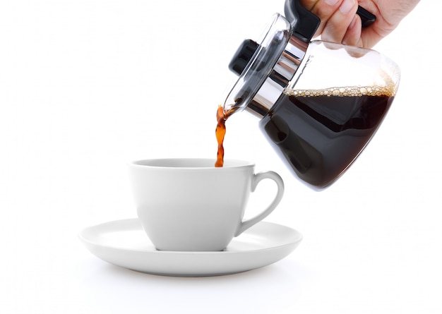 Photo pouring coffee on a cup isolated on white background