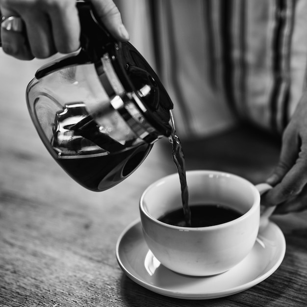 Pouring coffee from kettle