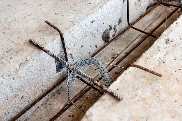 Pouring concrete lintels between the slabs at the construction\
site reinforcement and concreting of joints of floor slabs knitting\
wire