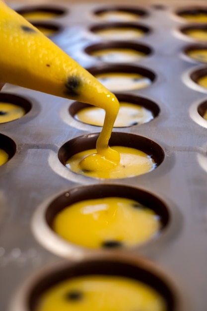 Photo pouring the filling into candies during the manufacturing process.