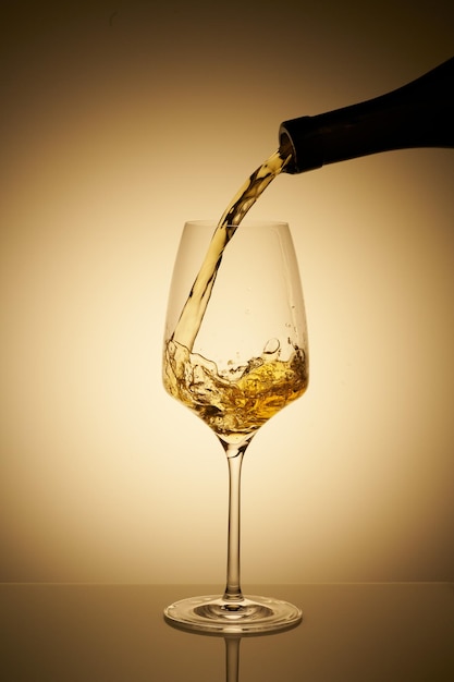 Pouring glass of white wine with copy space