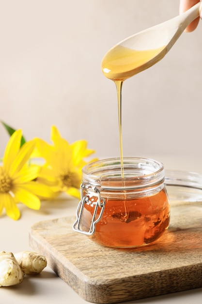 Pouring jerusalem artichoke syrup in glass jar