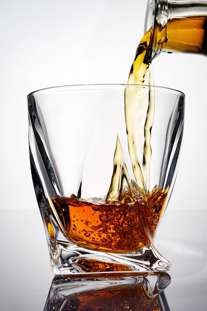 Pouring luxury whiskey into a crystal glass