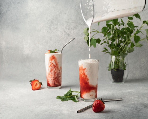 pouring a milkshake into a glass