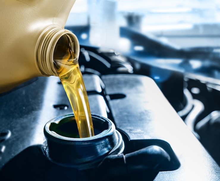 Photo pouring motor oil into the car engine