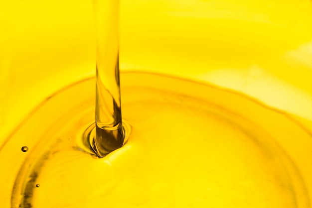 Pouring oil in bowl , car lubricant vegetable olive