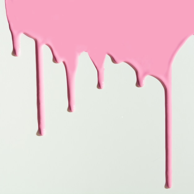 Pouring pink paint on white 