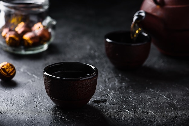 Pouring ready red tea into tea bowl