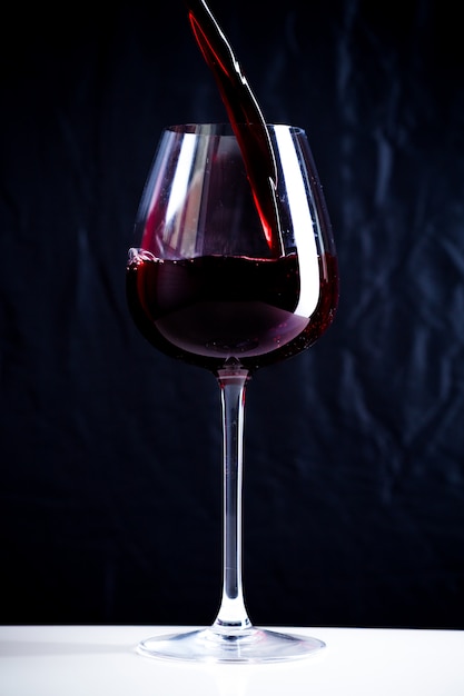 Pouring red wine into the glass