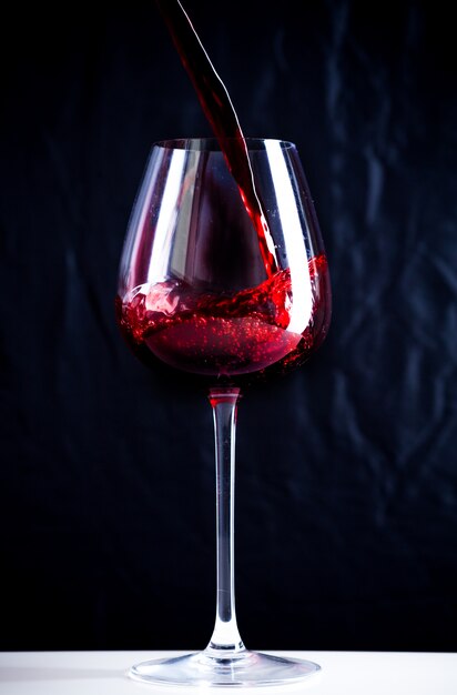 Pouring red wine into the glass