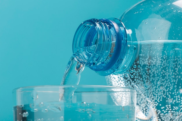 Pouring sparkling water in cup