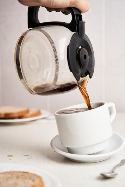 Pouring and spilling coffee on a white background